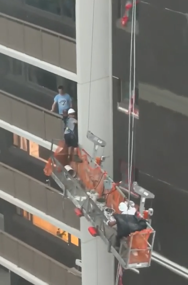 Workers Rescued from Dangling Scaffold During Storm
